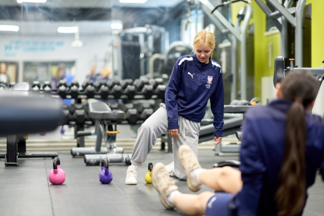 Students doing post match recovery exercises