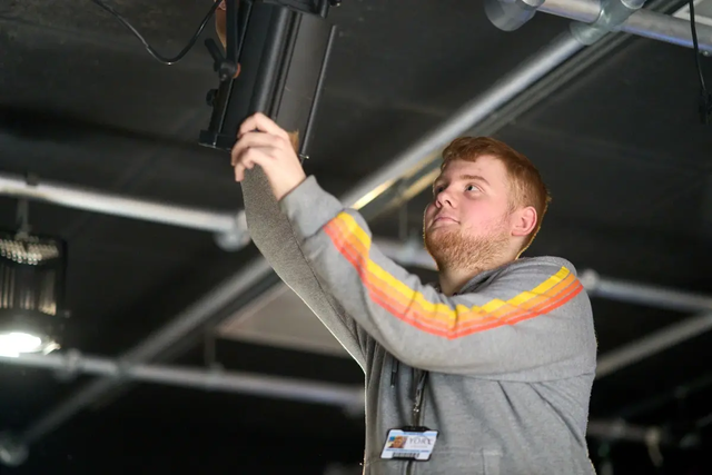 Student backstage arts lighting technician