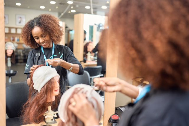 A student uses a cap to add highlights Level 1 Hairdressing Adult
