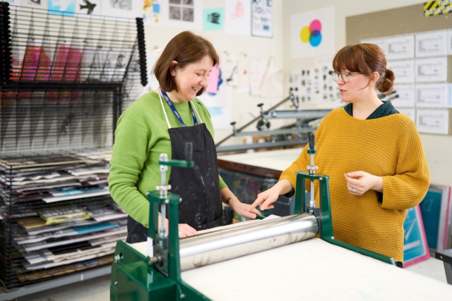 A student uses a roller press Graphics