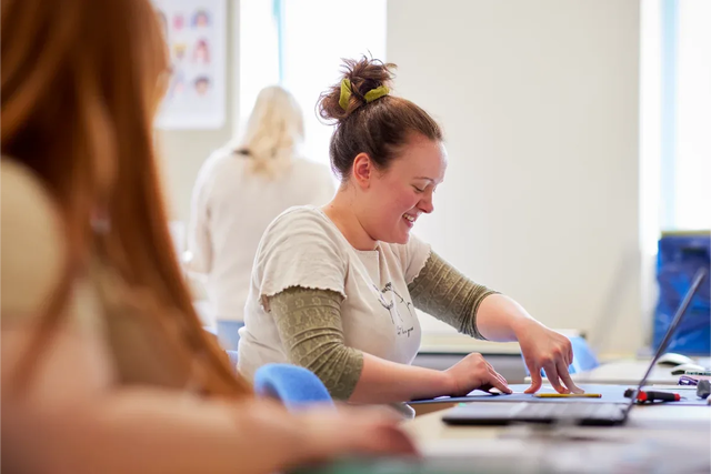 Graphic Design degree students working on projects in class 7