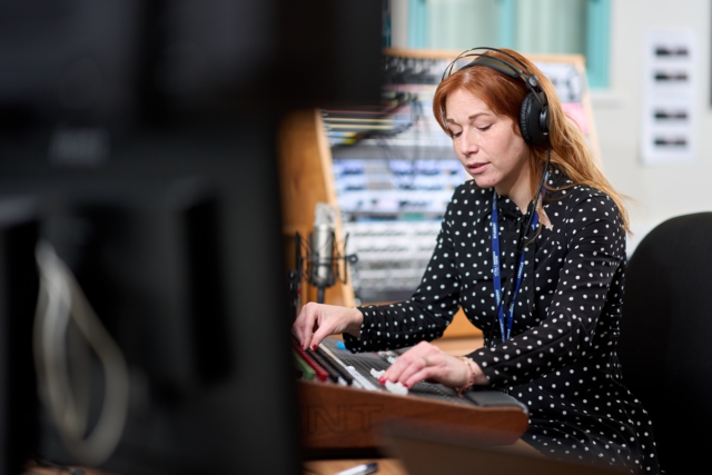A student uses a mixing desk Digital Music Production