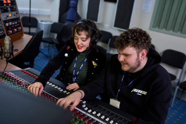 Two students use a mixing desk Digital Music Production